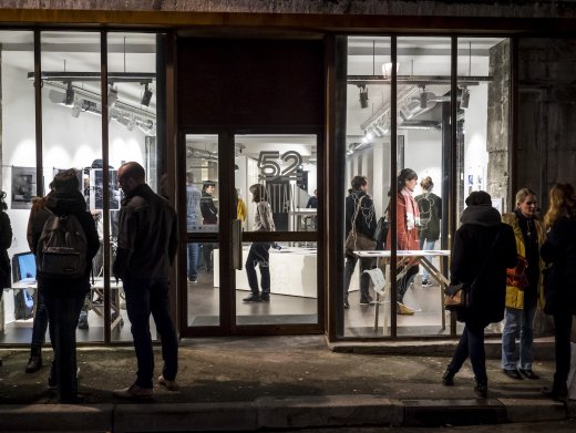 Des personnes dans et devant une salle vitrée